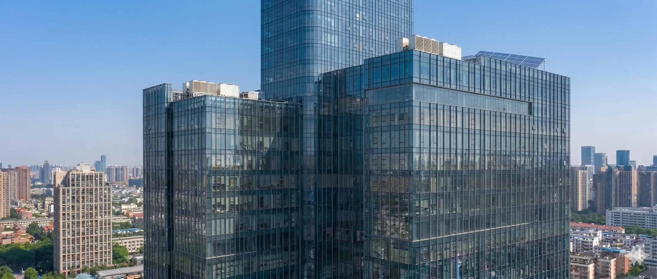 Modern glass office towers against a clear sky